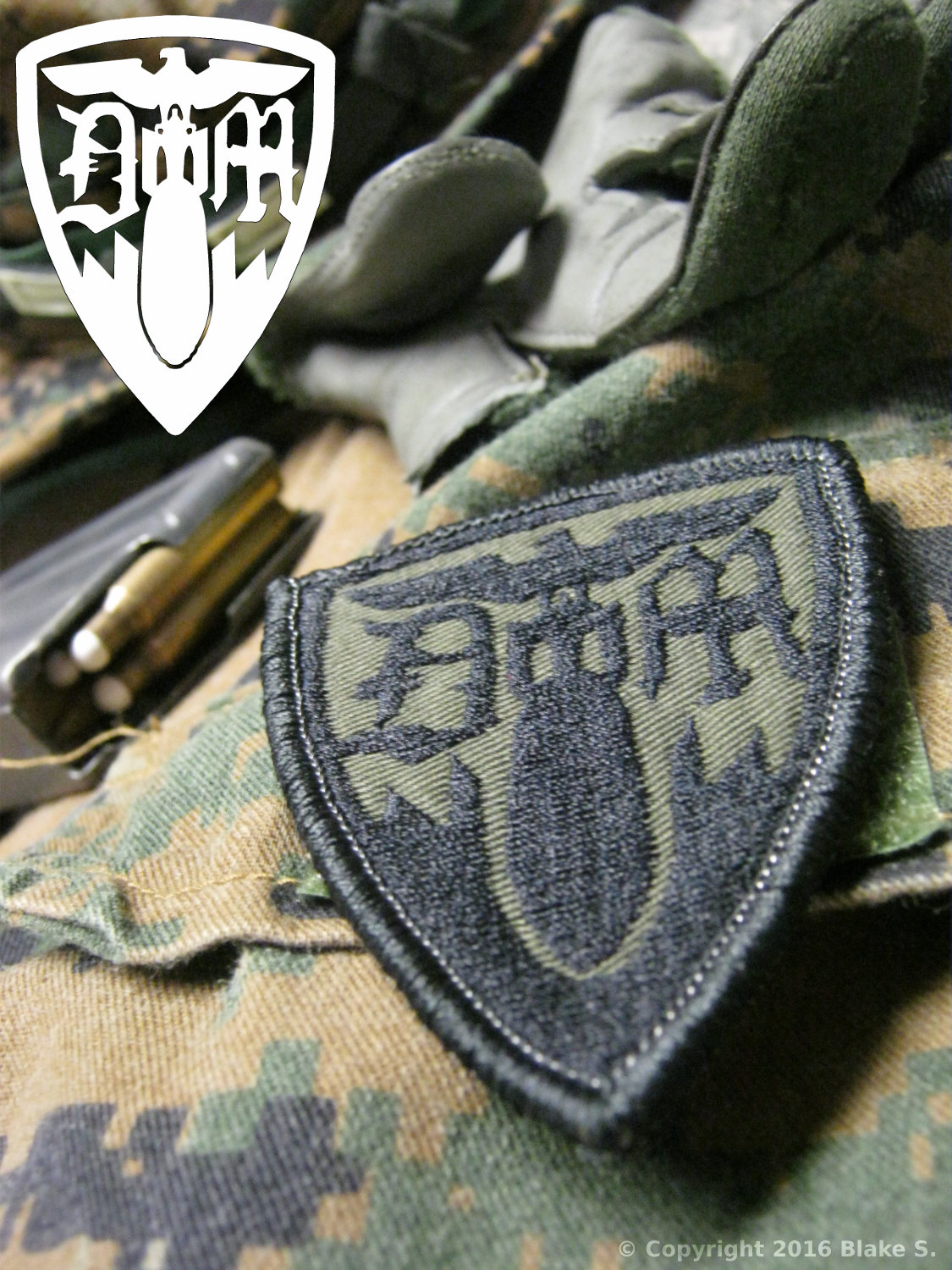 Doom squad logo by Omnitac. Shown in olive drab as a patch attached to a uniform.